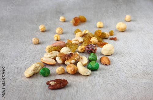 Assorted healthy mixed nuts on wooden textured background  