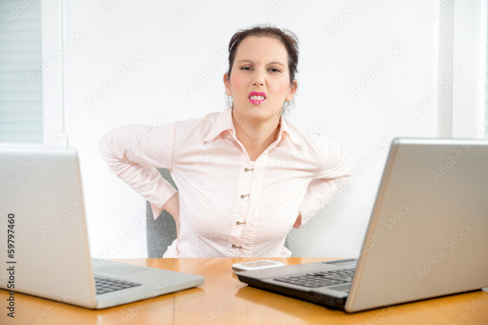 Young businesswoman having back pain Young businesswoman having back pain