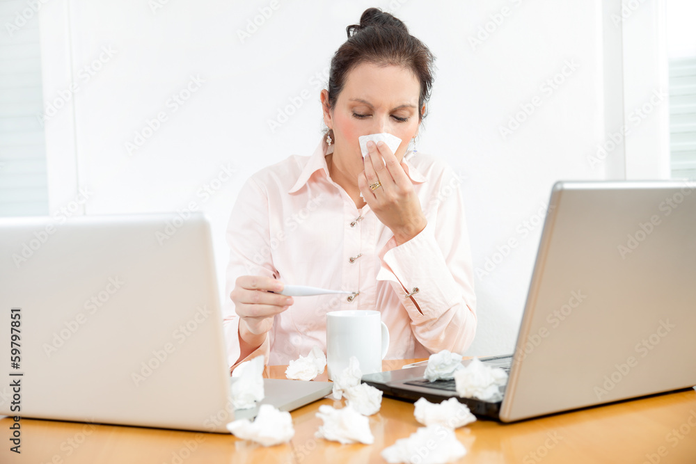 Young business woman measuring her body temperature Young business woman measuring her body temperature