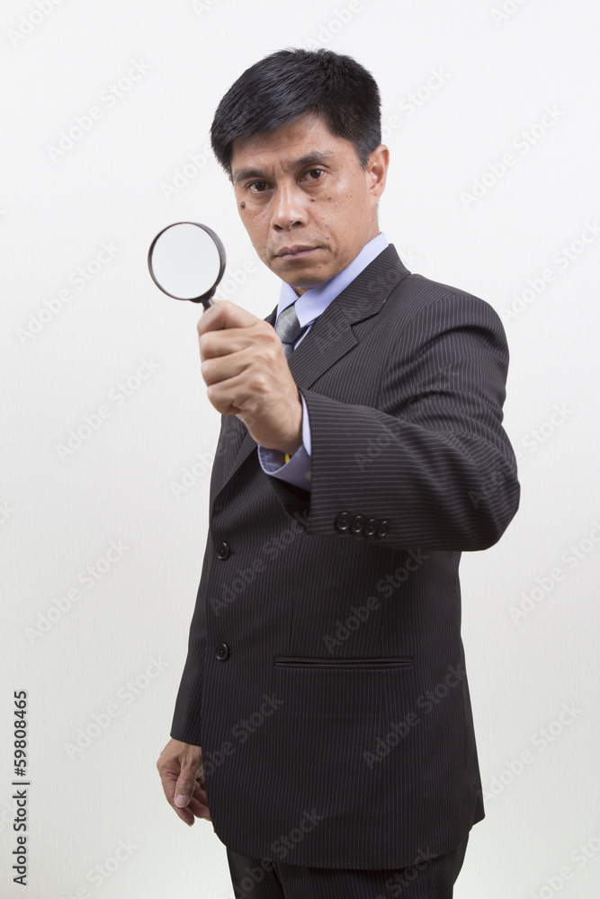 Businessman holding a magnifying glass. Businessman holding a magnifying glass.
