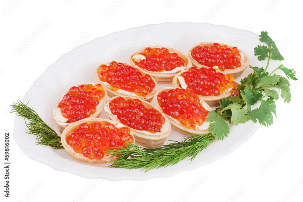 Tartlets with red caviar on plate isolated on white background. Tartlets with red caviar on plate isolated on white background.