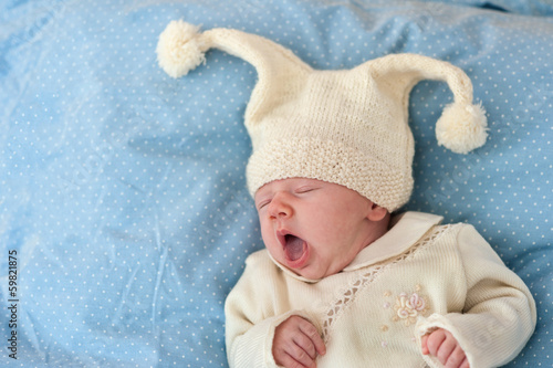 One month old baby yawning portrait.