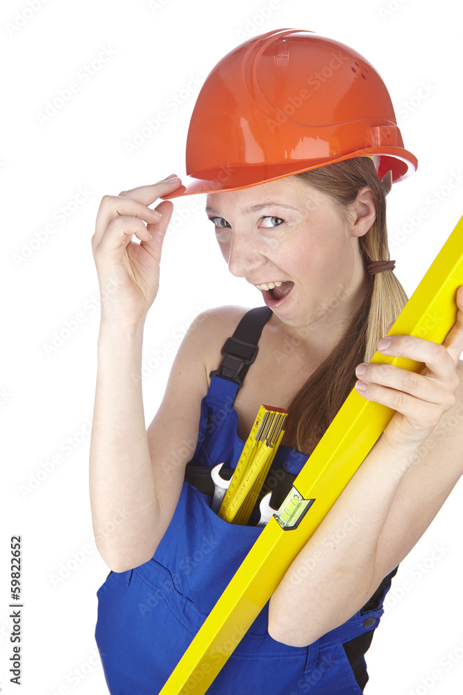 Handwerkerin mit Blaumann, Helm und Wasserwaage Handwerkerin mit Blaumann, Helm und Wasserwaage