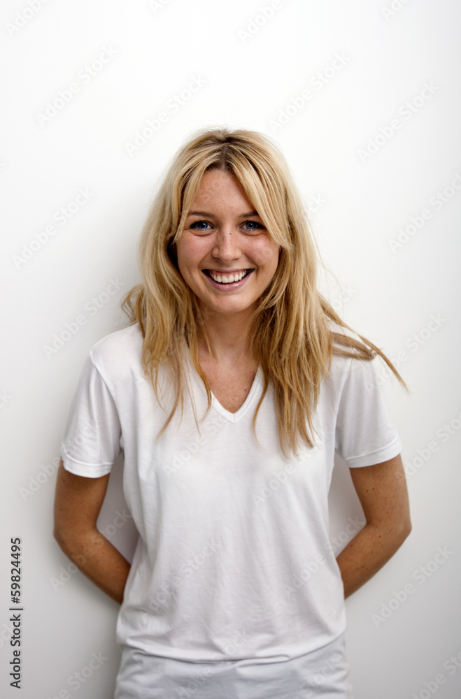 Portrait of happy woman standing against white background Portrait of happy woman standing against white background