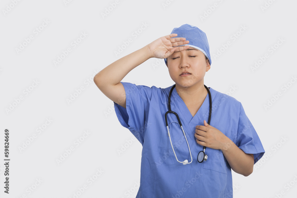 Tired female doctor with stethoscope around neck in hospital Tired female doctor with stethoscope around neck in hospital