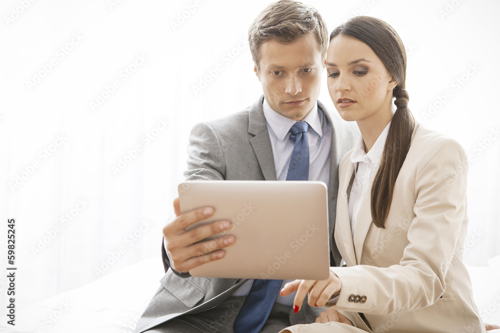 Businesspeople using digital tablet in hotel Businesspeople using digital tablet in hotel