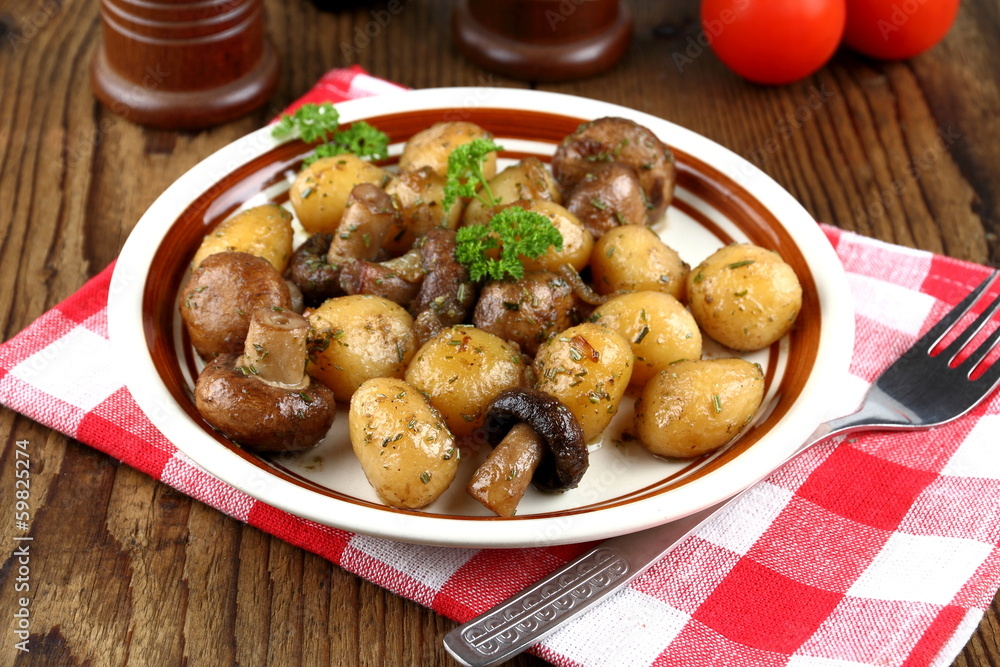 Brown champignons with rosemary potato and fork Brown champignons with rosemary potato and fork