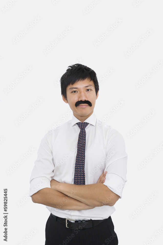 Portrait of confident businessman with fake mustache over white background Portrait of confident businessman with fake mustache over white background