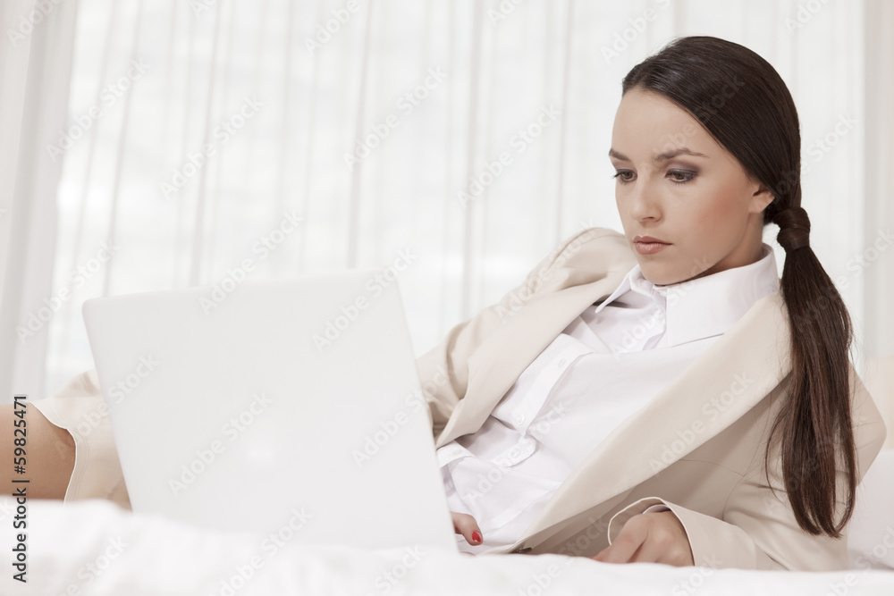 Businesswoman using laptop in hotel room Businesswoman using laptop in hotel room
