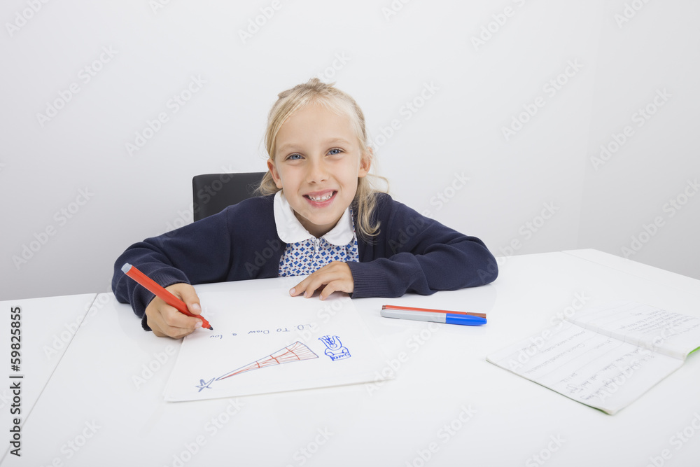 Portrait of happy girl drawing on paper at table Portrait of happy girl drawing on paper at table