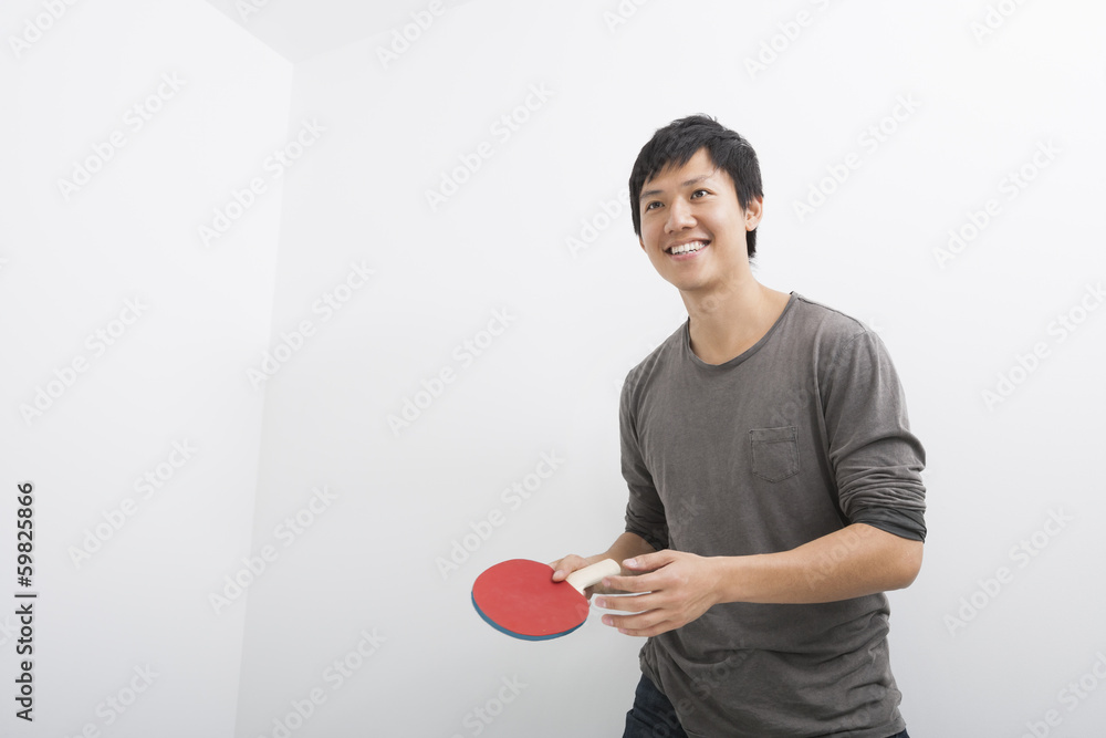 Handsome mid adult man holding table tennis paddle Handsome mid adult man holding table tennis paddle