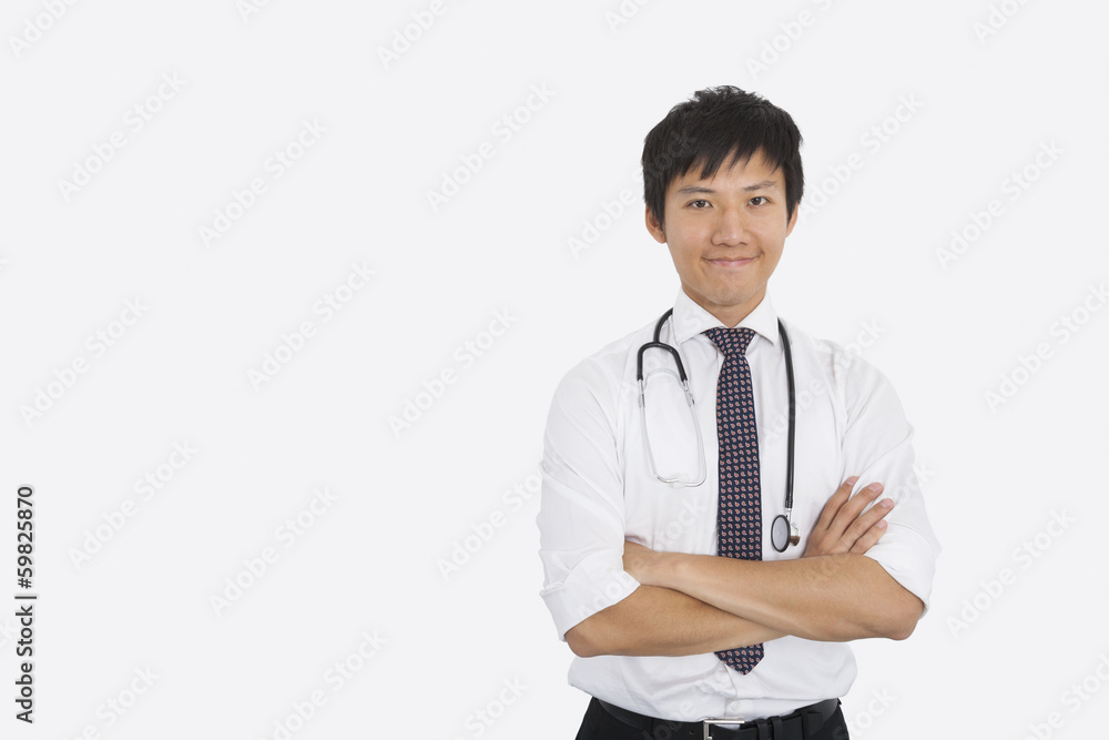 Portrait of Asian male doctor with arms crossed over white background Portrait of Asian male doctor with arms crossed over white background