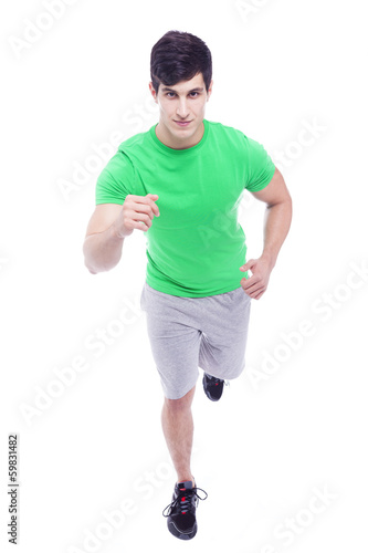 Athletic young man running, isolated over a white background