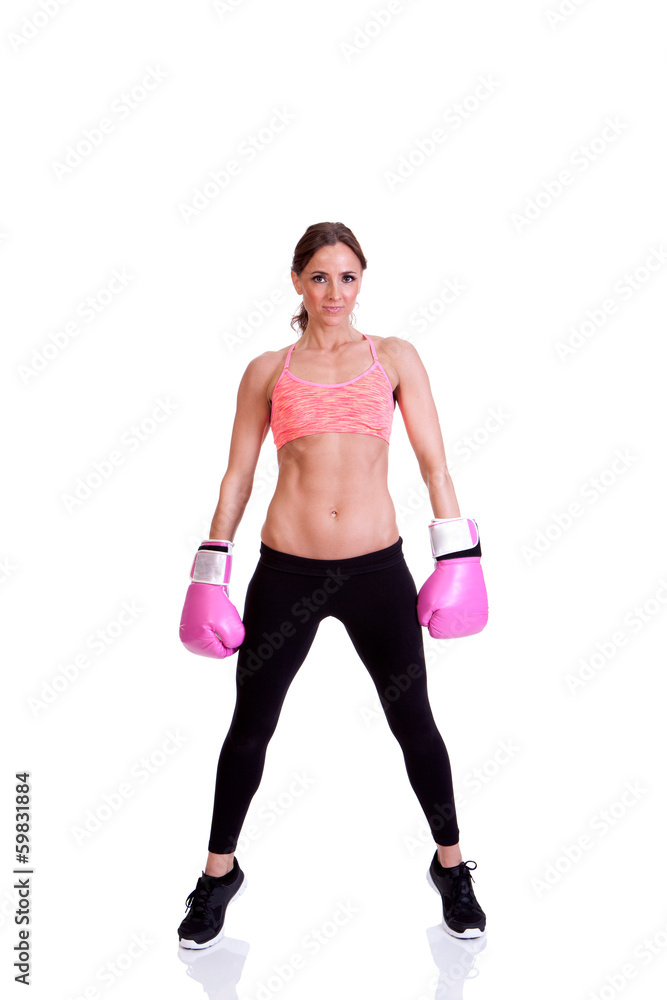 A beautiful young woman ready for a kickboxing exercise A beautiful young woman ready for a kickboxing exercise