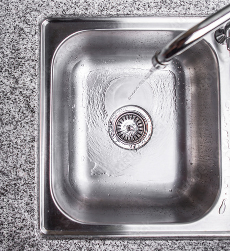 Принти на полотні Water flowing down the hole in a kitchen sink