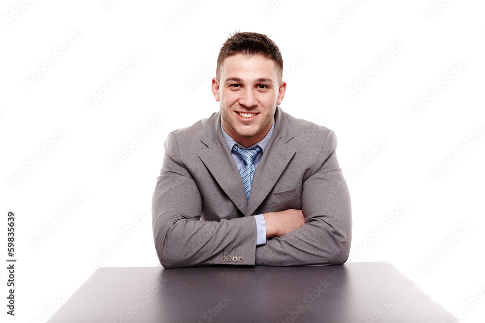 Cheerful businessman sitting with arms folded Cheerful businessman sitting with arms folded
