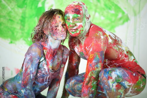 Man and girl sitting in studio with whole body in paint photo