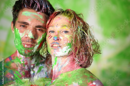 Portrait of man and girl in studio with whole body in paint photo