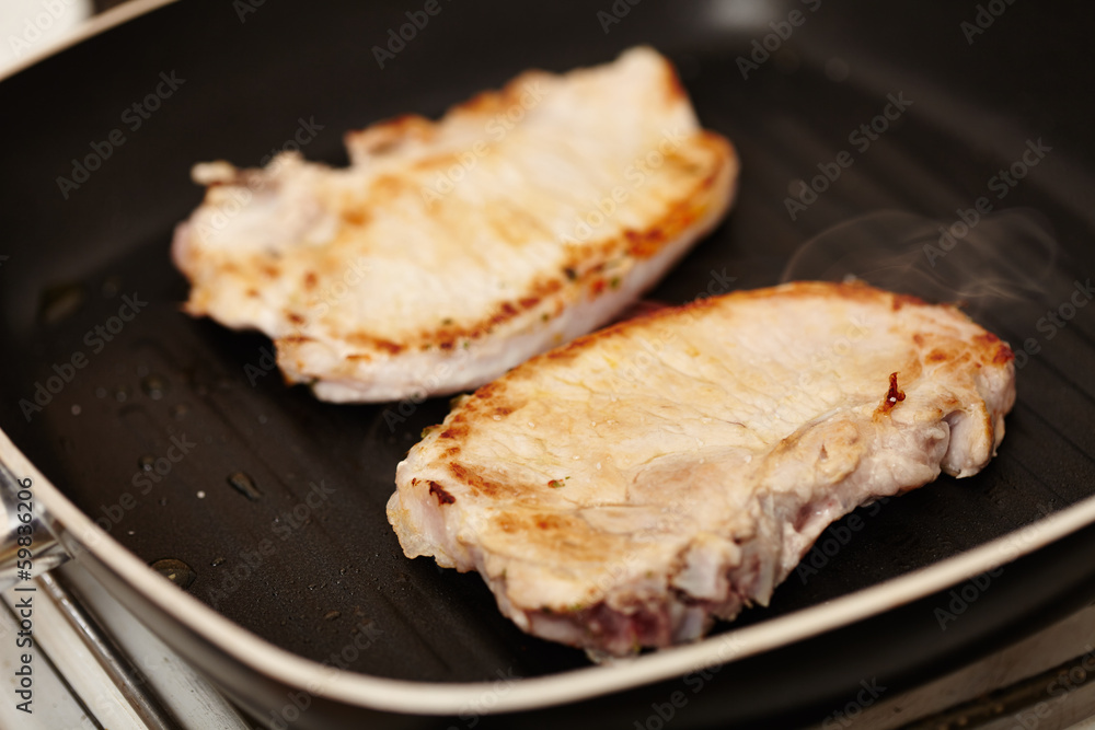 Fried pork chops in the frying pan Fried pork chops in the frying pan