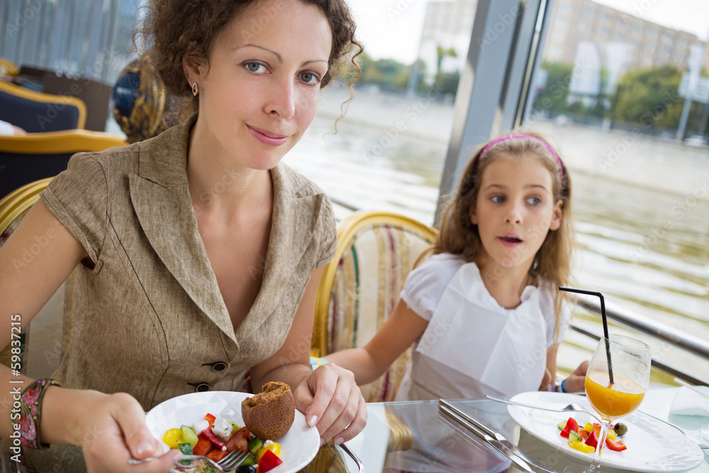 Mother and daughter eating at the floating  restaurant