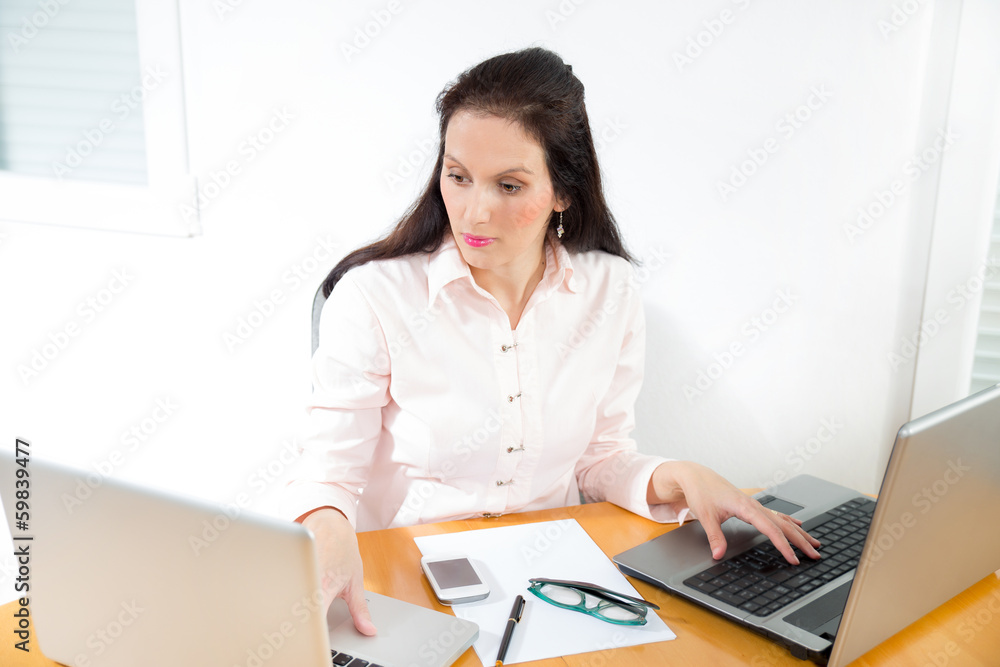 Portrait of a businesswoman with lots of work at office desk Portrait of a businesswoman with lots of work at office desk