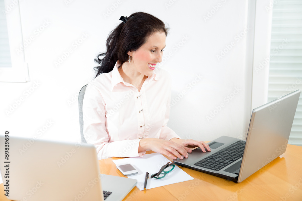 Portrait of a businesswoman with lots of work at office desk Portrait of a businesswoman with lots of work at office desk