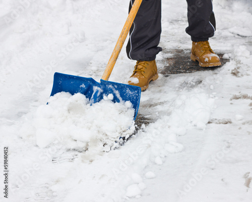 Clearing snow with shovel after storm