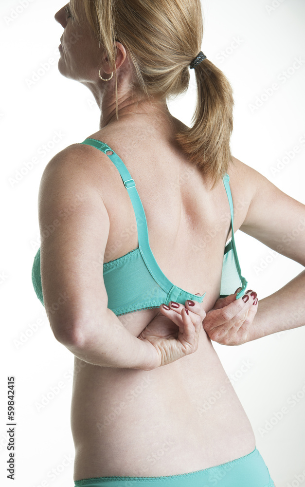 Woman adjusting her green coloured bra Stock Photo