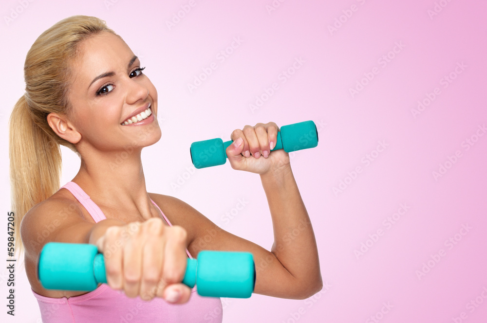 Beautiful young female exercising with dumbells Beautiful young female exercising with dumbells