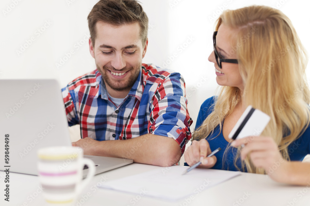 Couple paying bills by credit card Couple paying bills by credit card