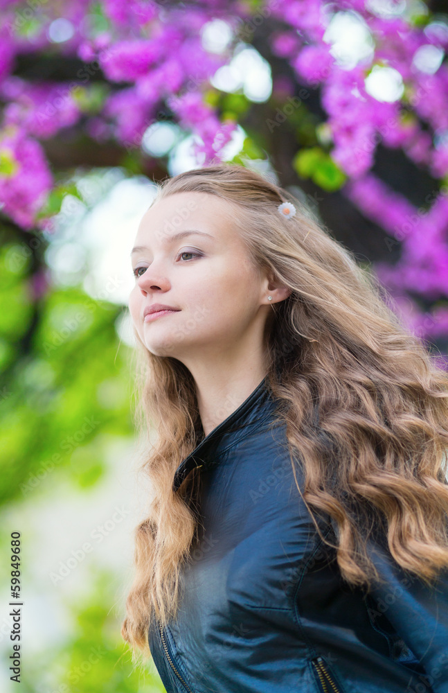 Romantic young girl with lilac in the background Romantic young girl with lilac in the background