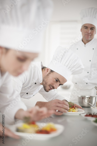 Portrait of a chef preparing dinner carefully