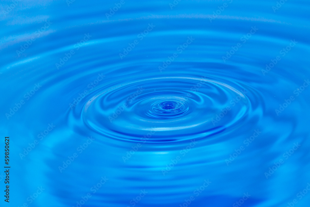 abstract background. drop falls in blue water abstract background. drop falls in blue water