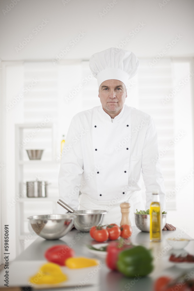 portrait of a senior chef in his kitchen portrait of a senior chef in his kitchen