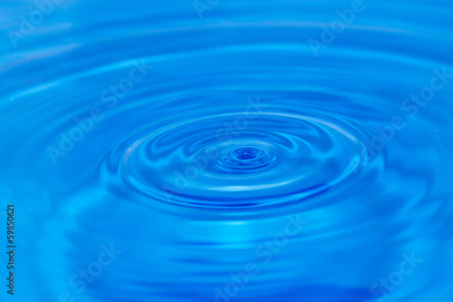 abstract background. drop falls in blue water
