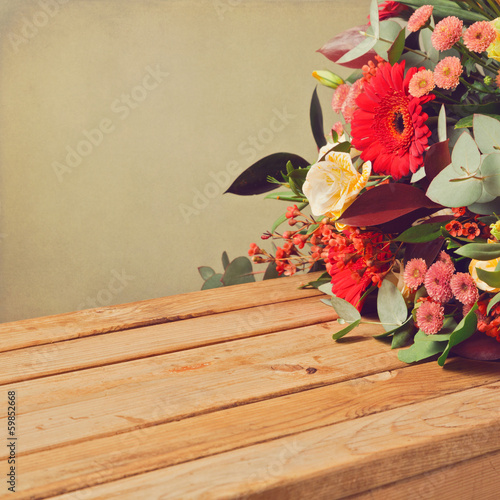 Retro backgrouns with flowers and wooden table