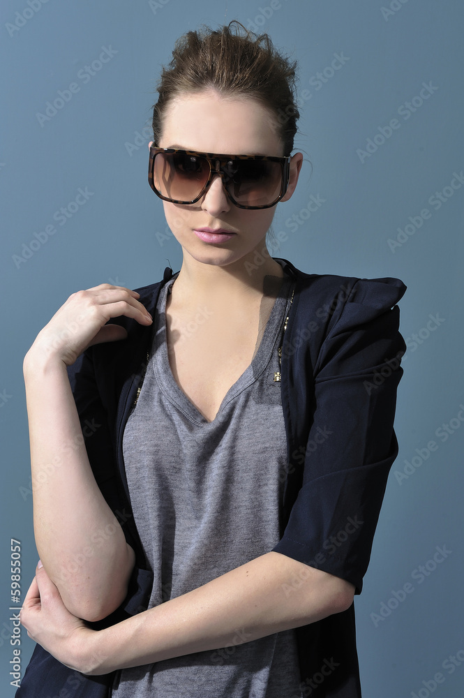 young woman in sunglasses standing posing young woman in sunglasses standing posing