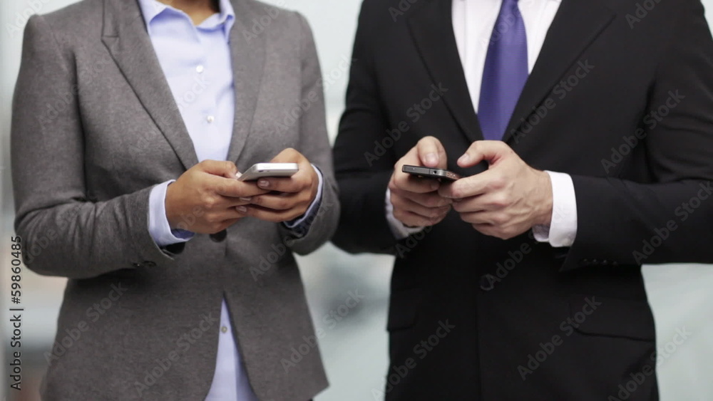 businessman and businesswoman with smartphones businessman and businesswoman with smartphones