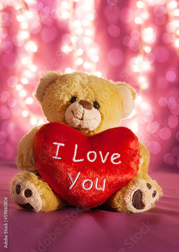 Little teddy bear with big red heart