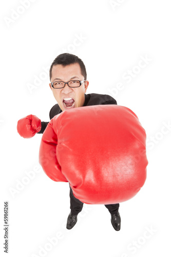 screaming businessman attack to enemy with boxing gloves photo