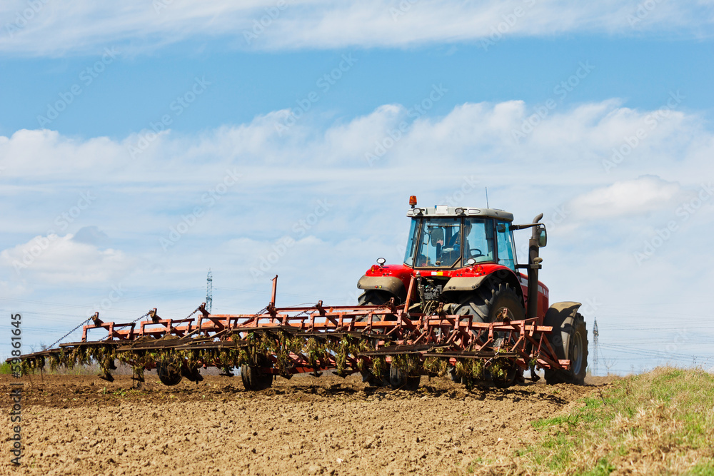 Fototapeta premium Farmer plowing the field