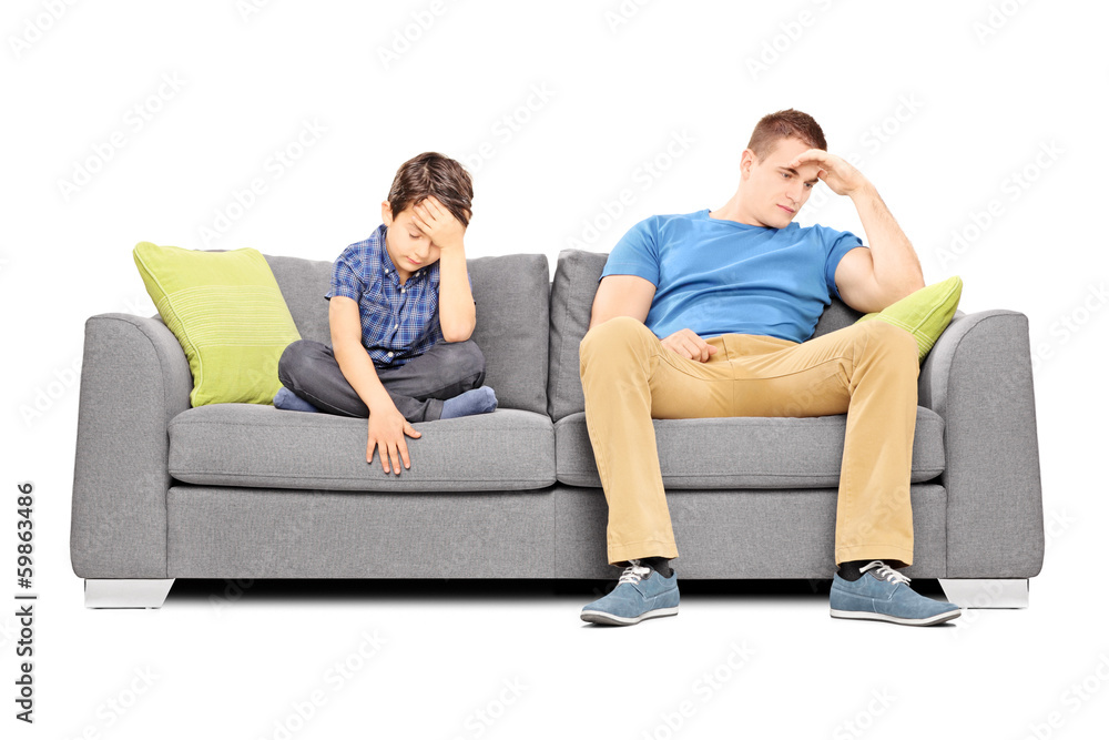 Dissappointed brothers sitting on a sofa Dissappointed brothers sitting on a sofa
