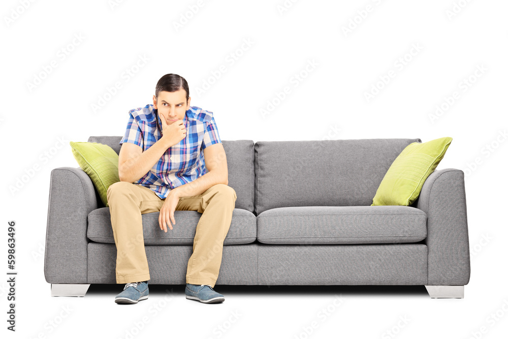 Obraz premium Worried young businessperson sitting on a sofa