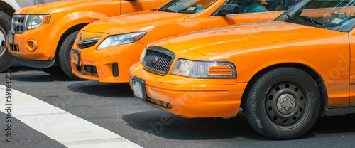 Taxis in New York. Yellow cabs in pole position at traffic light