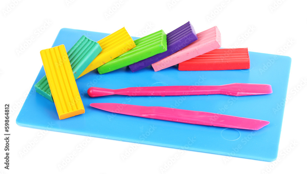 Children bright plasticine on desk with stacks isolated on Children bright plasticine on desk with stacks isolated on