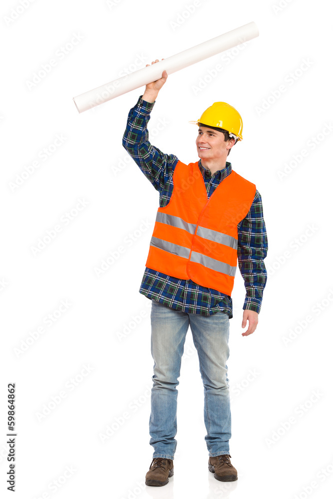 Construction worker holding rolled paper plan. Construction worker holding rolled paper plan.