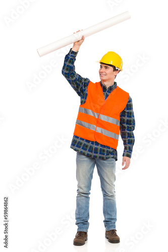 Construction worker holding rolled paper plan.