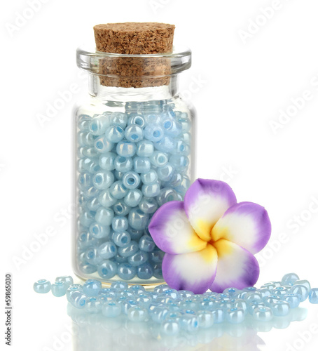 Little bottle full with colorful beads isolated on white