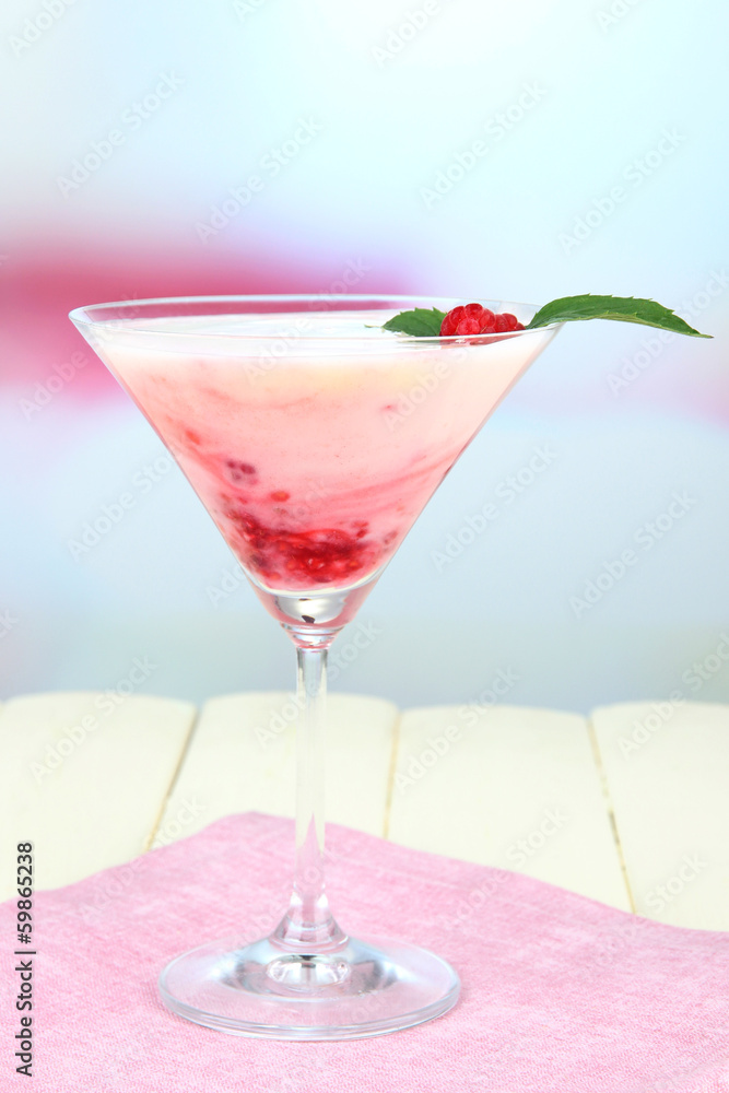Raspberry milk dessert in cocktail glass, on light background Raspberry milk dessert in cocktail glass, on light background