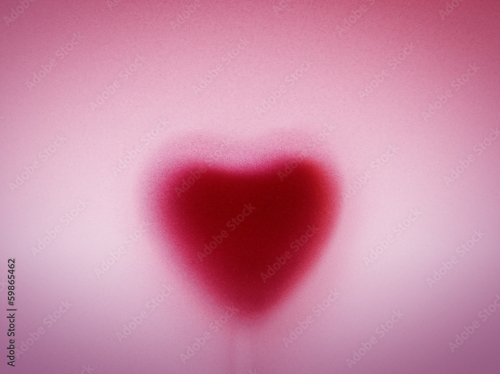 Heart shape behind milky frosted glass. Love background